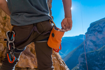 Man is climbing with magnesium powder.