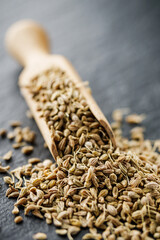 aromatic dry anise seeds on a dark black stone background