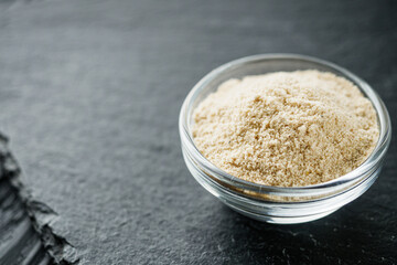asafoetida aromatic powder on a black stone background