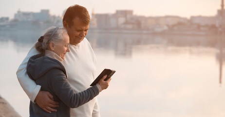 Happy couple spends time togever near the river in the city.