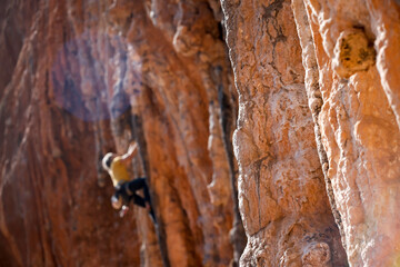 A man is climbing on the rocks in the mountains.