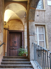Fototapeta na wymiar Traboule and old door in Lyon old district of Saint Jean, picturesque historic passageways between streets 
