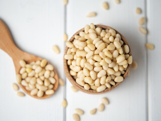 tasty and healthy pine nuts in a wooden bowl and spoon