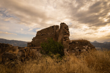 The remains of Bentomiz castle which was a moorish constructed fort on the top of a hill near Arenas in the mountains of Andalusia above Malaga. Spanish name is Castillo Bentomiz