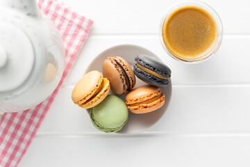 Sweet macaron dessert. Colorful macarons on plate. Top view.
