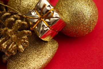 various golden christmas ornaments on red background