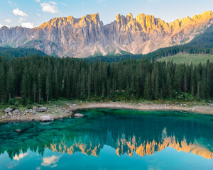 Sunrise over emerald lake in Dolomites mountains