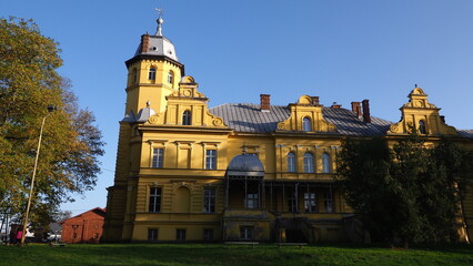 
A yellow baroque palace (Pałac von Plötzów) with a dome, North West Poland