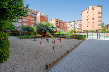 Fototapeta na wymiar Gardens and playground of an urbanization with common areas