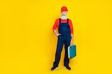 Full size photo of pensioner artisan workman standing with mechanical tool box isolated on bright color background