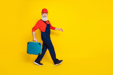 Profile side full body photo of retired technician go hold tool box isolated on bright color background