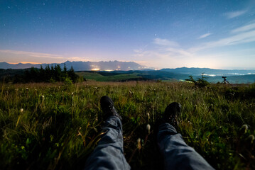 Night view of High Tatras from Panska Hola, Low Tatras National Park Slovakia.Green meadows and mountains in the background. Sitting under the night sky. © Filip