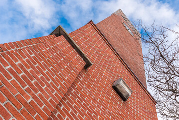 Looking up at the outside of the tall brick clock tower in Stouffville Ontario Canada.