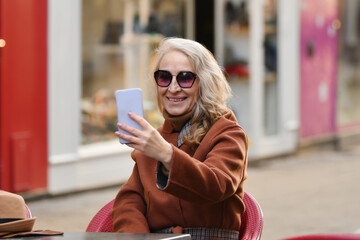 Blonde woman talking on video call and smile