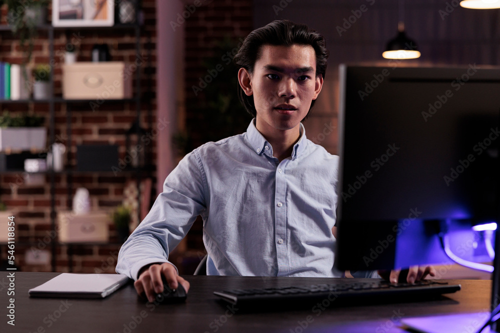 Poster office employee working on freelance task, creating business report on computer and planning researc