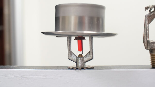 Fire sprinkler heads with fusible links and frangible bulbs