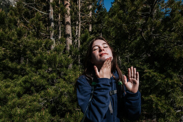 Teen girl putting sunscreen on chin before hike