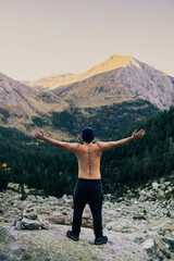 Boy looking at an impressive mountain landscape from the top