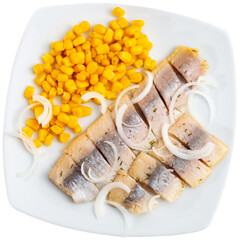 Delicious herring with onion and corn on white square plate. close-up. Isolated over white...