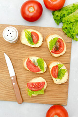 Bruschetta sandwich bread toast with cheese ricotta,fresh tomatoes,basil greenery.healthy vegan food