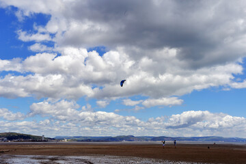 Cloudy blue sky landscape photo with parachute kite.