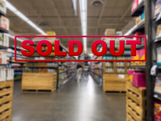 Blurry focus on a customer shopping inside a grocery store with the words Sold Out in the foreground