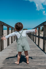 Boy playing on a wooden bridge