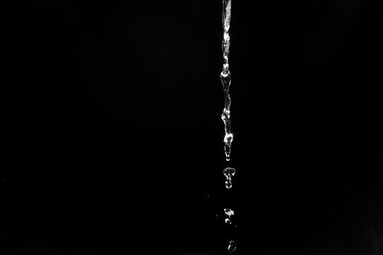 water splashes isolated on black background. white jets with drops