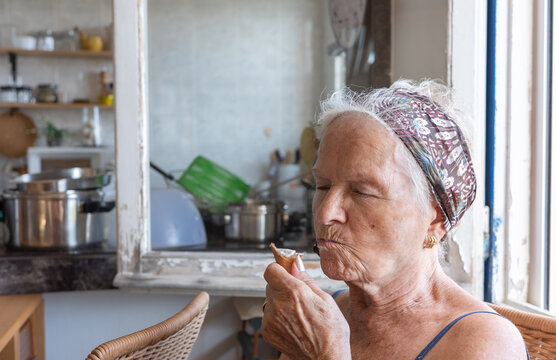 White Haired Octogenarian Elderly Woman Eating An Ice Cream