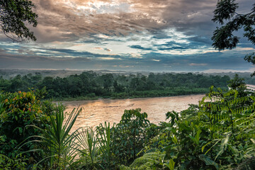 Panorama top view on the Napo river during sunset and beautiful golden reflection on the water and lush vegetation. Napo river is one of Ecuador's physical features and a tributary to the Amazon River