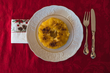 Caramelized pineapple from above with brwon sugar. Xmas dessert ready to eat with christmas napkin.