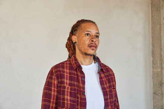 man standing facing to side 