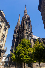 Fototapeta na wymiar Towering over Clermont-Ferrand city gothic cathedral Notre-Dame-de-l'Assomption building from black lava, France
