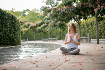 Girl practice yoga meditation outdoor in park