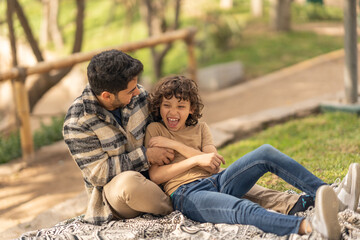 Playful father and son in a park