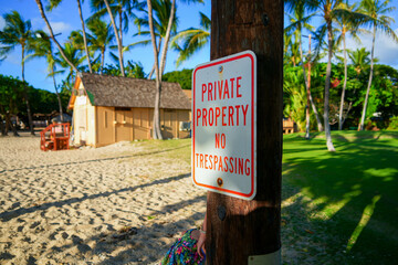 Kapolei, Hawaii / February 23, 2022 : Private property sign on the Paradise Cove Public Beach in Ko Olina, a touristic area on the western shore of O'ahu island in Hawaii, United States