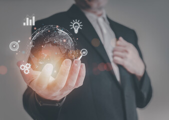Businessman or trader is showing a growing virtual hologram stock on smartphone, planning and...