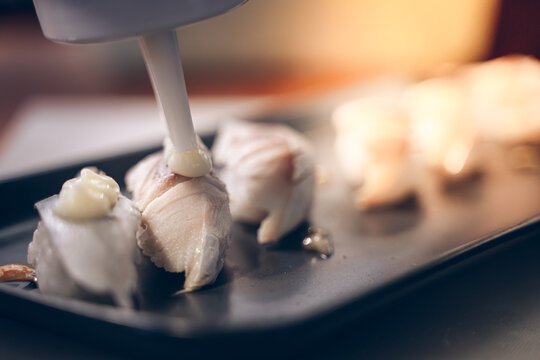 Chef is making sushi to serve customers. sushi is a street food of japan and new business in the world.