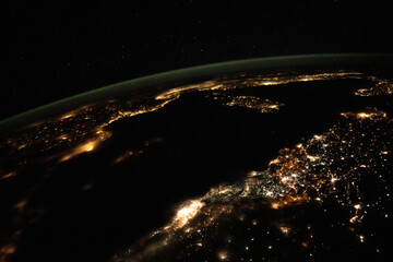 Aerial space view, cities light up the night. Nighttime view from space of the Mediterranean Sea from north Africa to southern Europe. Elements of this image furnished by NASA.