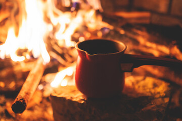 Warming up the fire, cozy winter night in the scandinavian cottage house cabin by the fireplace,...