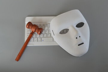 Judge gavel, laptop keyboard and handcuffs isolated on a grey background. Copy space for the text....