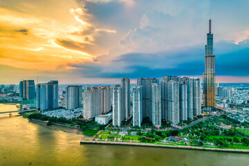 Fototapeta premium Top view aerial of center Ho Chi Minh city, Vietnam, beauty skyscrapers along river urban development, transportation, energy power infrastructure. Financial, travel and business concept.