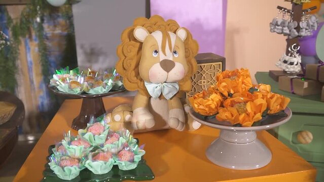 Decoration for children's party with candy, flowers and stuffed animal