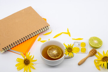 herbal drinks honey lemon, lozenge and notebook planner arrangement flat lay style on background...