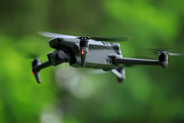 Flying drone in summer forest