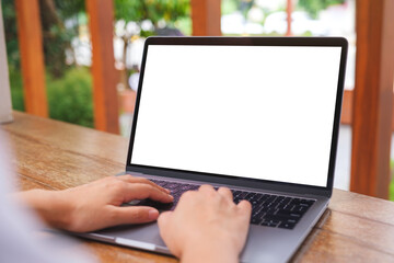 Mockup image of a woman using and typing on laptop computer with blank white desktop screen