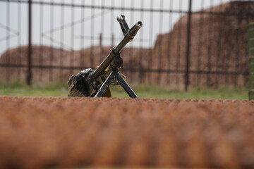 Almaty, Kazakhstan - 04.14.2022 : A Kalashnikov assault rifle is mounted against the background of...