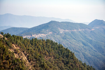 Fototapeta na wymiar Panoramic view of windy road on the ridge of the mountains