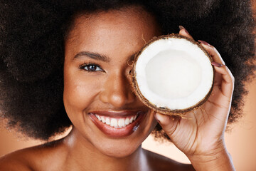 Coconut, skincare and beauty of a black woman model smile about cosmetic wellness and health. Portrait of a woman face holding fruit for diet, hair care and skin glow with natural healthy nutrition