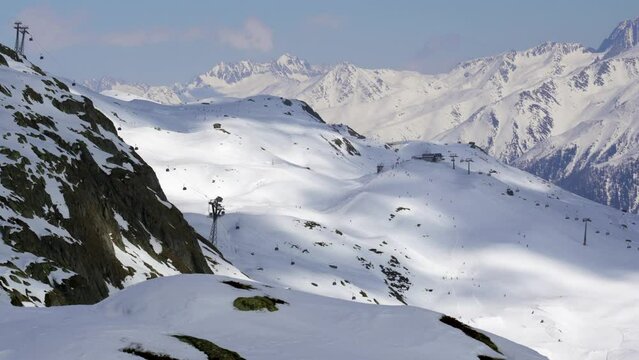 Distant ski resort and ski pistes in the Aletsch Arena area of Switzerland in the snow-capped mountains of the alps in Switzerland
